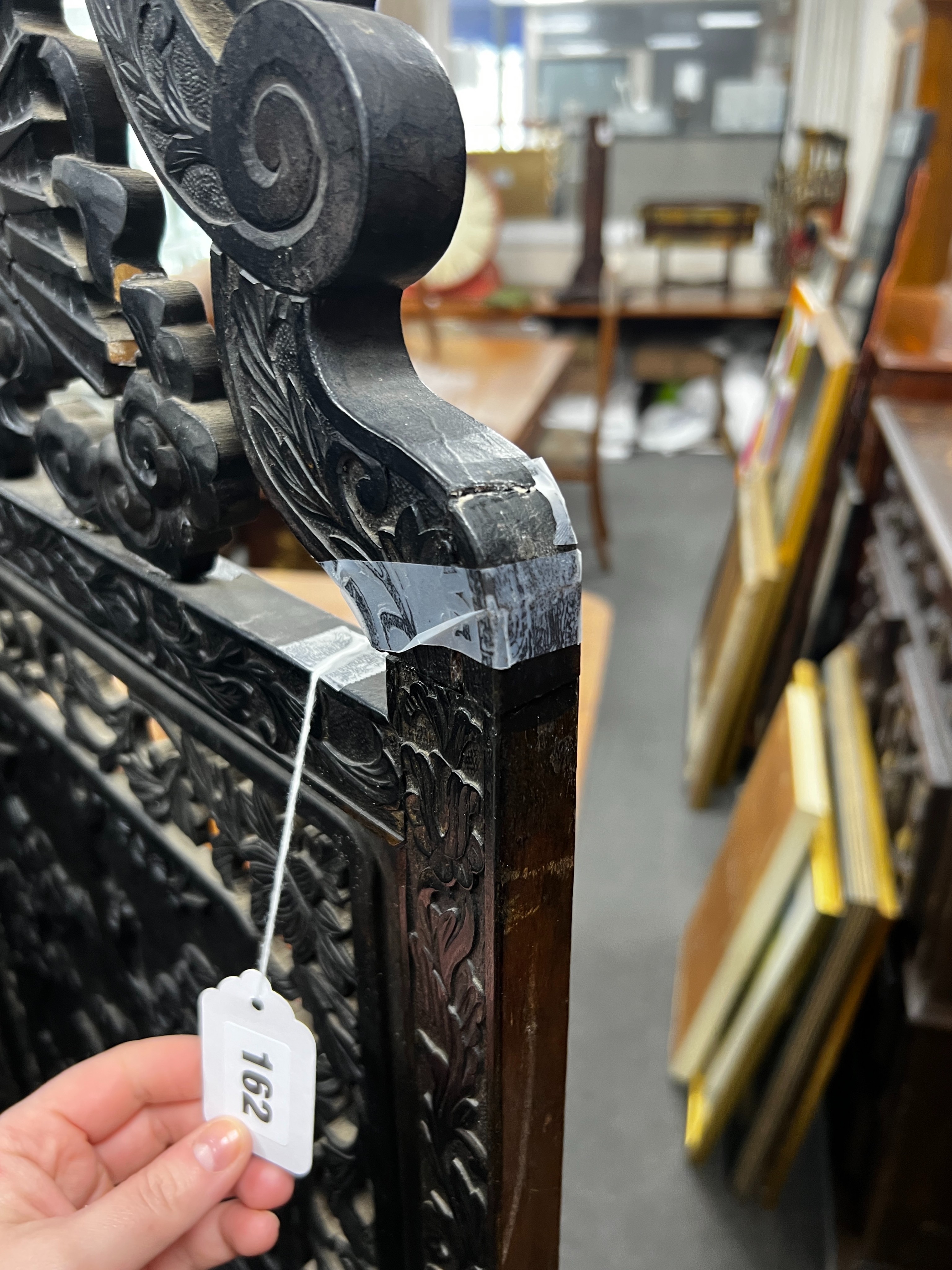 An early 20th century Japanese carved ebonised wood four fold dressing screen, width 56cm, height 173cm